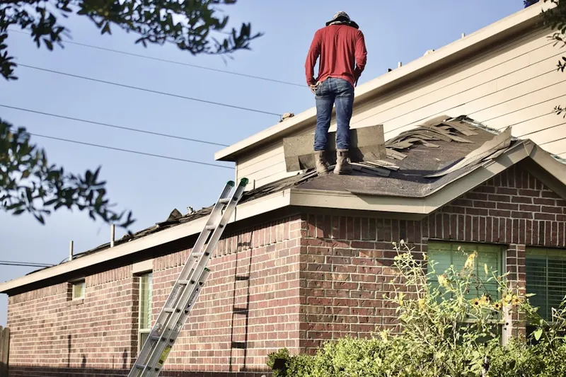 Professional roofer working on a residential roof in McVan